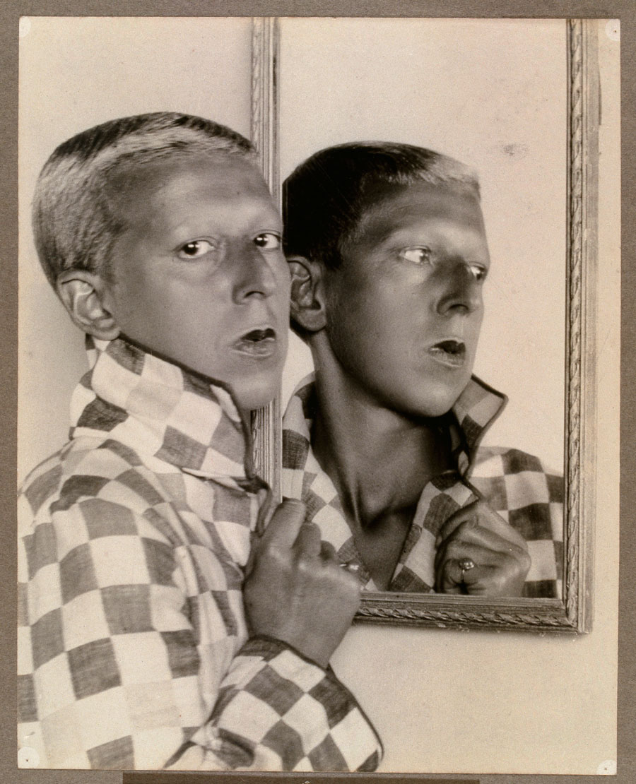 Claude Cahun :: Self-portrait [reflected image in mirror with chequered jacket], 1927-1928-1929.
