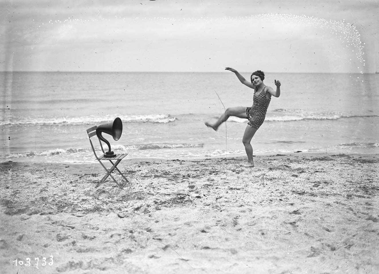 Miss Vera Cooper poses for journalists on the beach of the French resort of Deauville, France, August 21, 1925. Glass negative. Agence Rol. 
