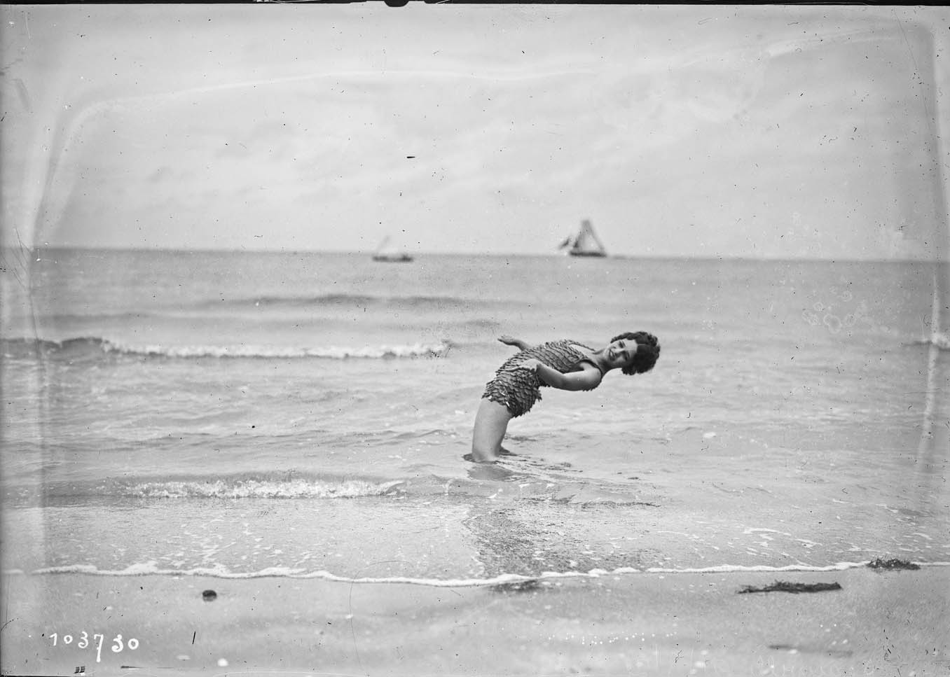 Miss Vera Cooper poses for journalists on the beach of the French resort of Deauville, France, August 21, 1925. Glass negative. Agence Rol. 