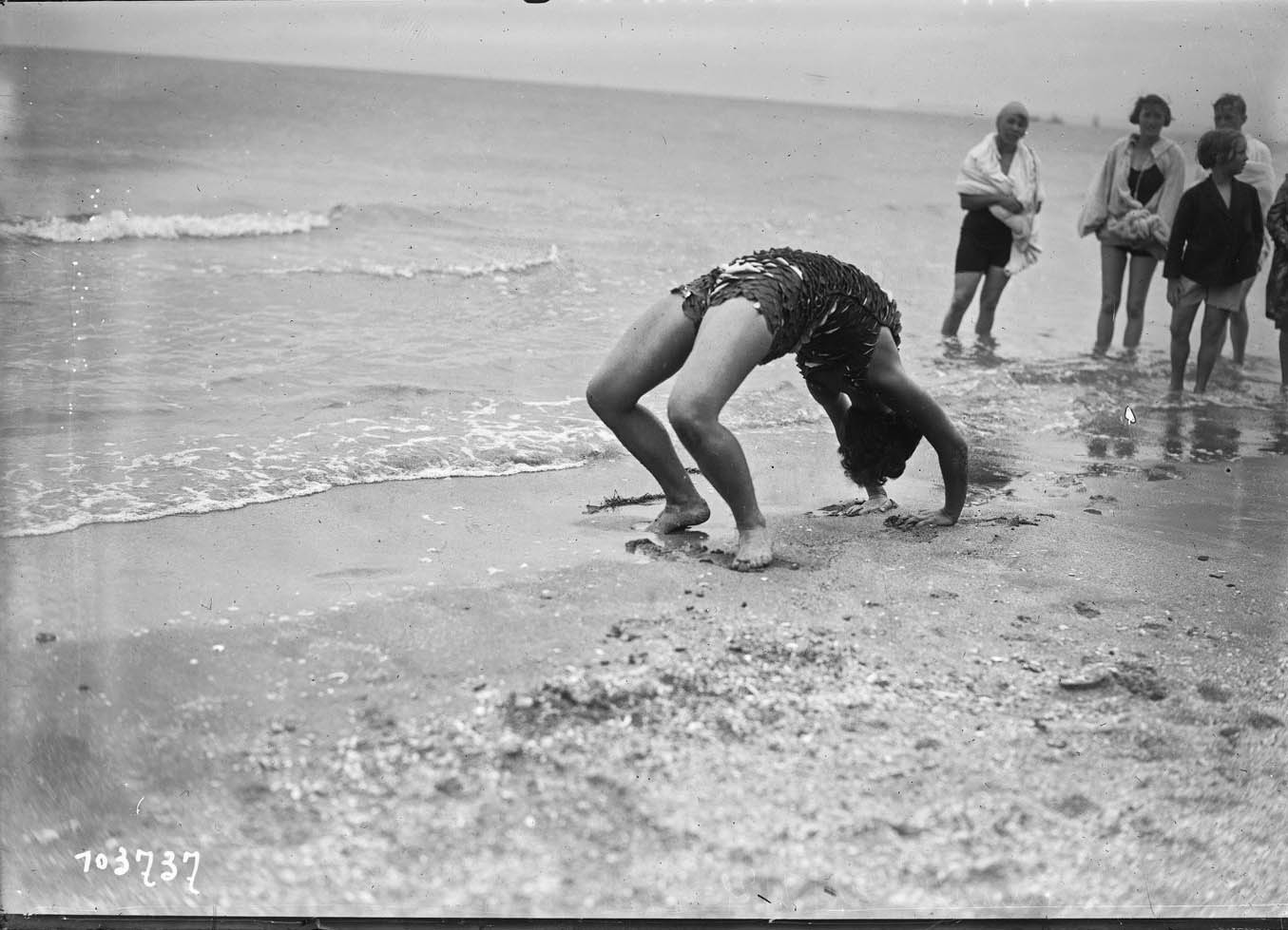 Miss Vera Cooper poses for journalists on the beach of the French resort of Deauville, France, August 21, 1925. Glass negative. Agence Rol. 