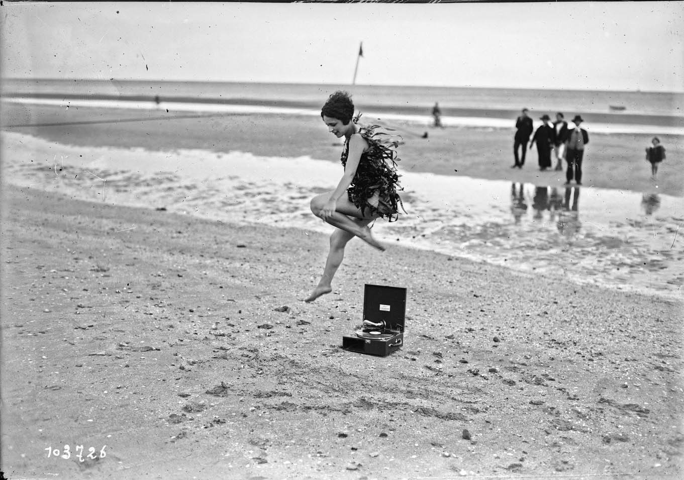 Miss Vera Cooper poses for journalists on the beach of the French resort of Deauville, France, August 21, 1925. Glass negative. Agence Rol. 