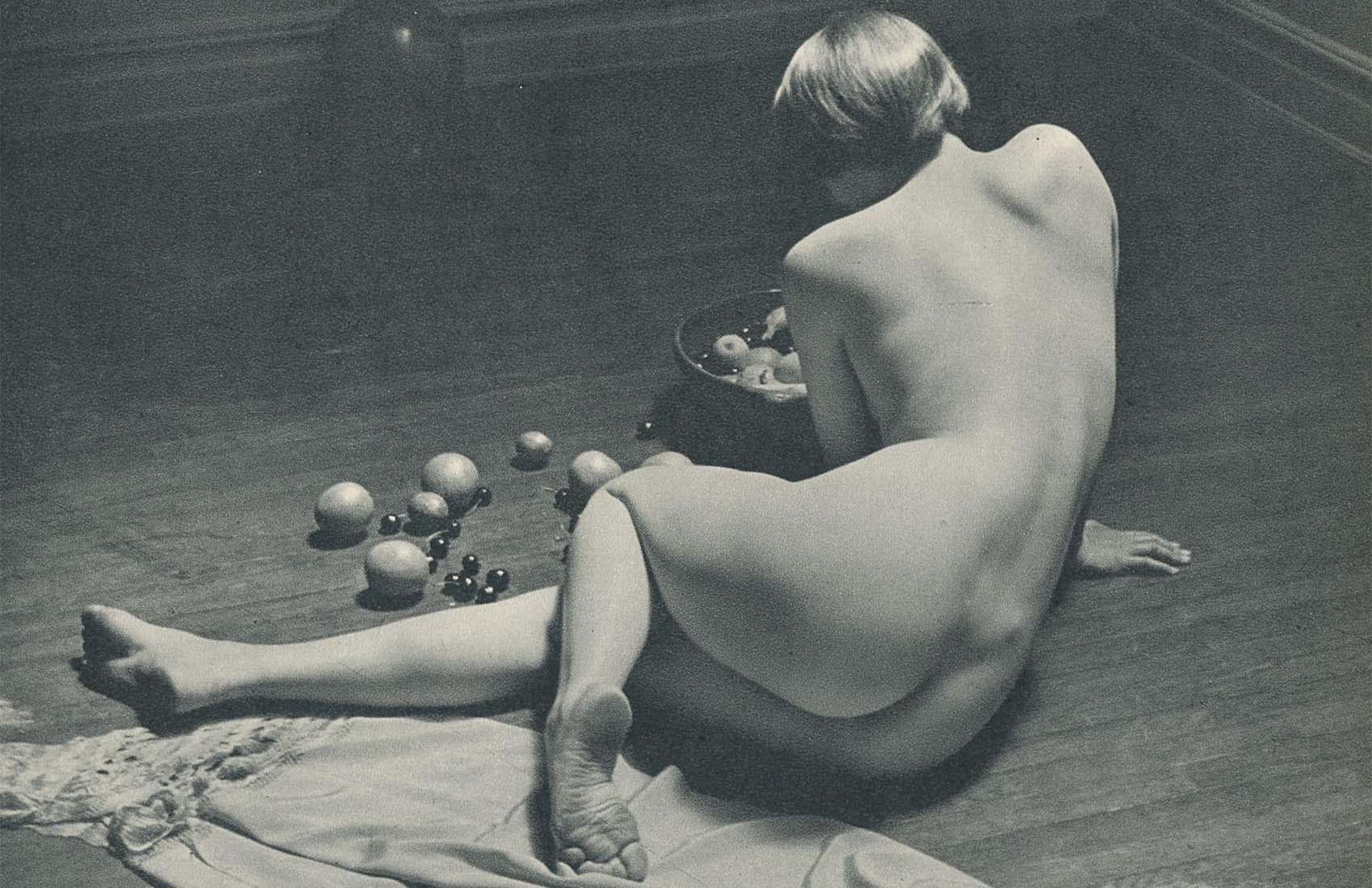 André de Dienes :: Nude (on floor with still life of fruits), ca. 1950. Photogravure from «The Nude». | src liveauctioneers
